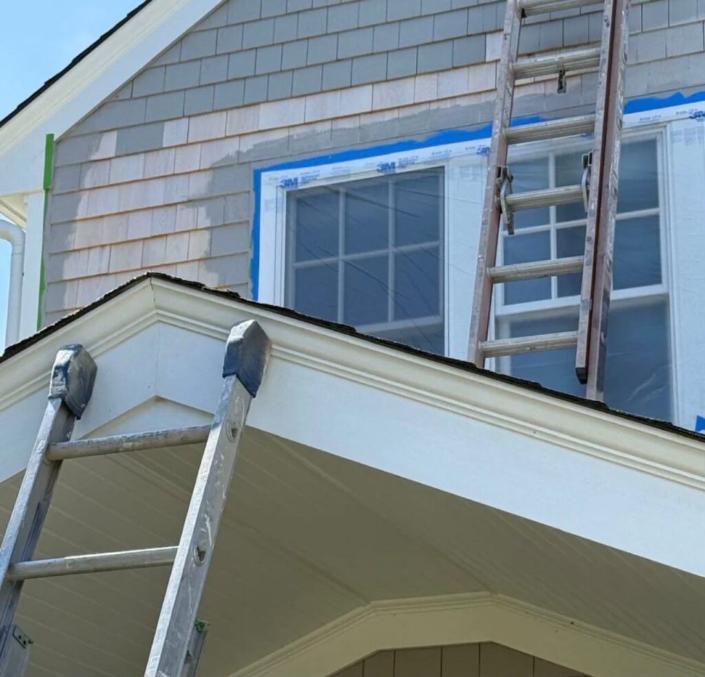 Exterior cedar shingle repaint in progress on a Cape Cod home